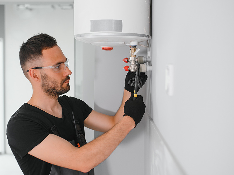 Airtech technician servicing valves during a residential boiler repair appointment