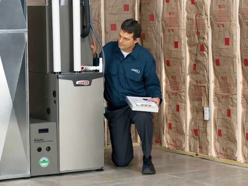 Airtech Mechanical Heating & Cooling technician inspecting a high-efficiency residential heating unit after a furnace installation