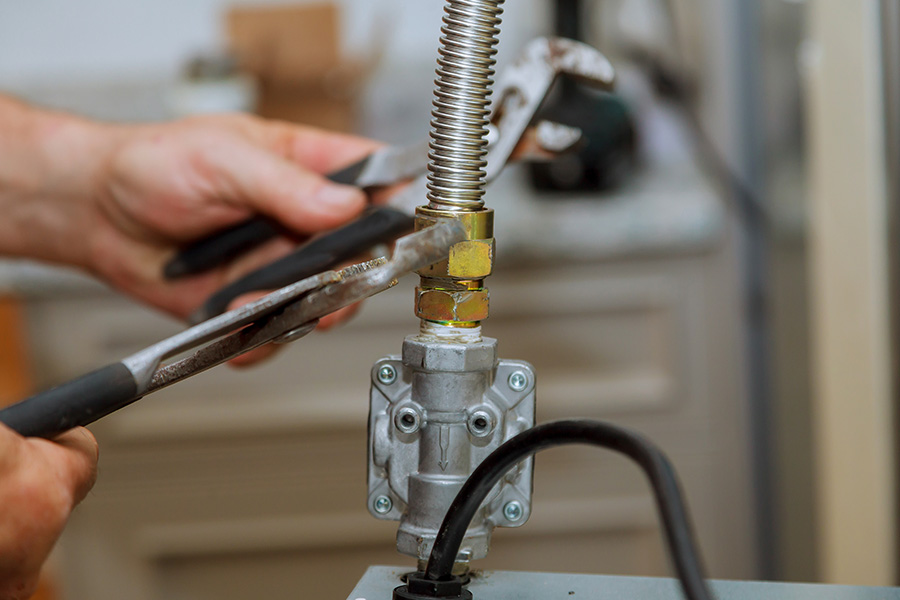 Airtech Mechanical technician tightening flexible CSST piping for gas line repair in Livonia, MI
