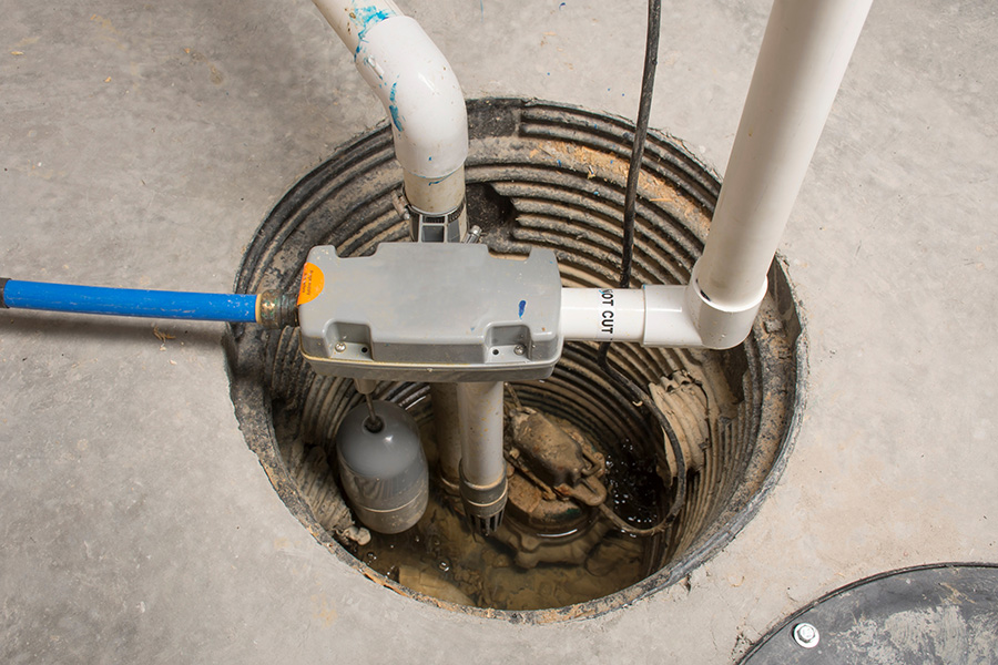 Basement sump pit with pump system requiring professional sump pump repair in Livonia, MI