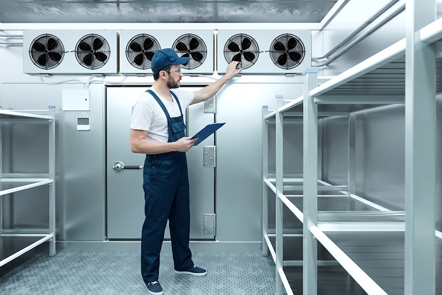 Technician performing commercial walk-in cooler repair in Livonia, MI